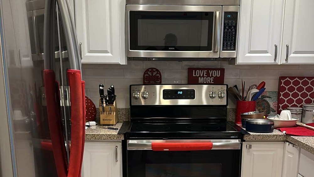 A residential kitchen after a clean, counters clear and appliances streak-free
