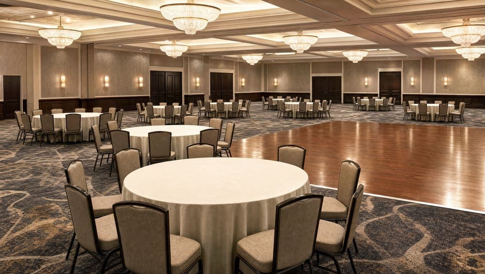A banquet hall reset after an event, linens pressed and chairs aligned